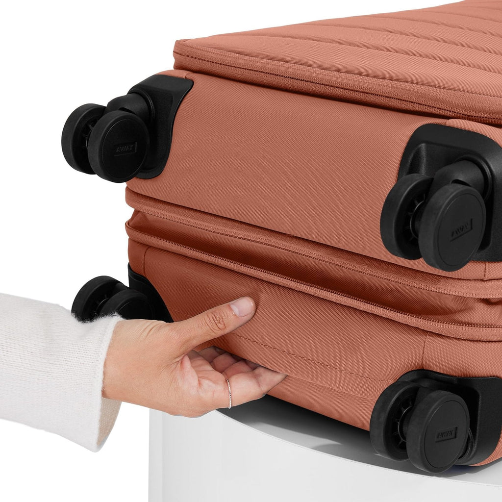 Away Softside Carry - On Suitcase, 22 Inch Expandable High - Strength Nylon Luggage With Spinner Wheels, Meets Requirements for Most Major Airlines, Clay Pink