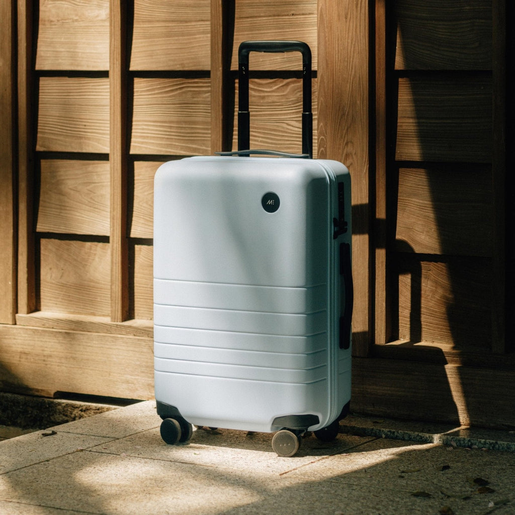 Monos Medium Checked Luggage (26.5"), Lightweight Hardside Spinner Suitcase with TSA Lock, Durable Travel Case, Blue Haze