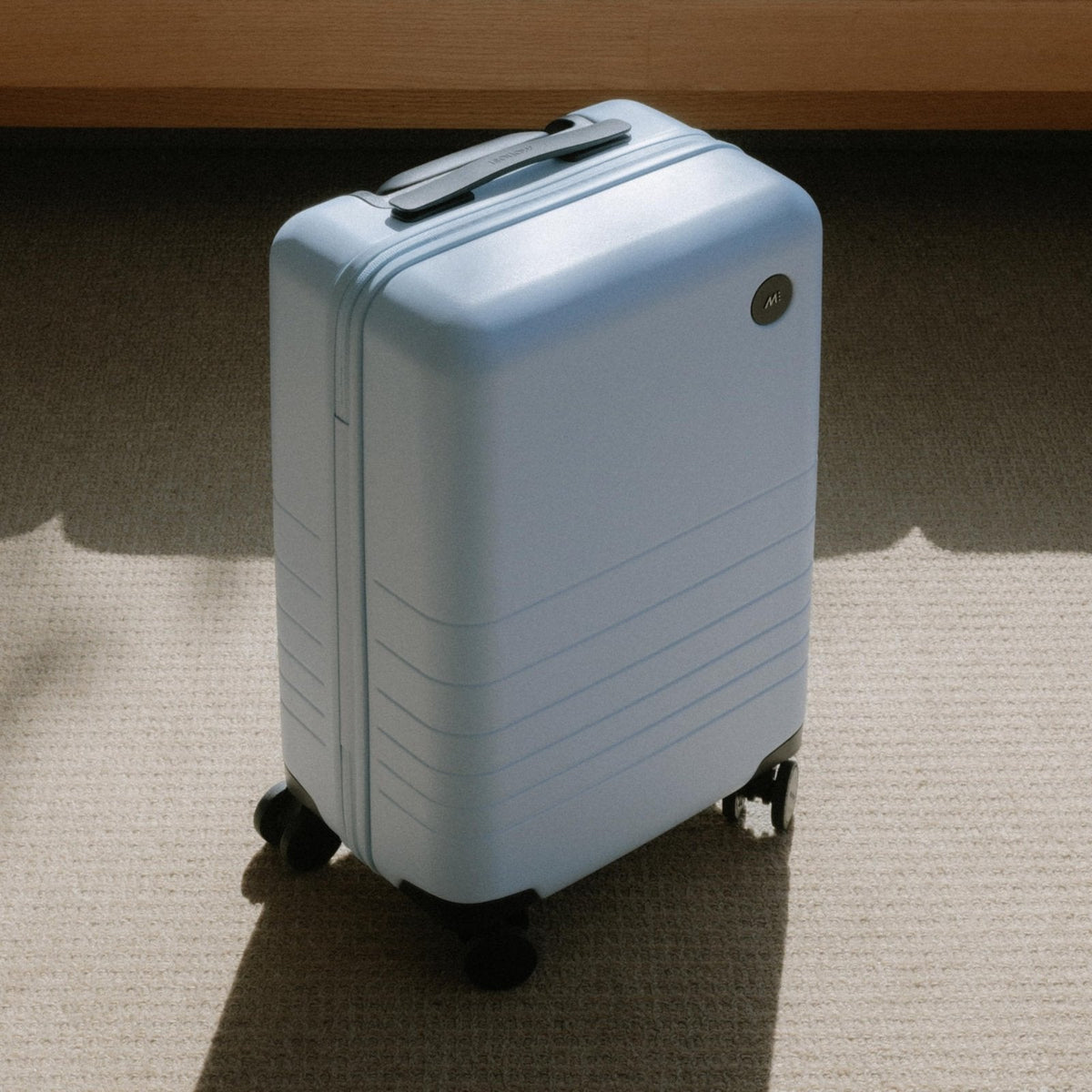 Monos Medium Checked Luggage (26.5"), Lightweight Hardside Spinner Suitcase with TSA Lock, Durable Travel Case, Blue Haze
